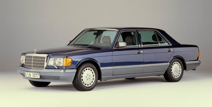 Your favourite car from the year you were born in... - Page 12 - General Gassing - PistonHeads - The image showcases a sleek, vintage Mercedes limousine, painted in a two-tone color scheme with royal blue and white. The vehicle is positioned at a three-quarter angle, allowing a detailed view of its luxurious front end and exquisite five-spoke wheels. The Mercedes emblem is prominently displayed on the grille, signifying the car's prestigious make. The interior of the car is visible from the side windows, but the focus remains on the exterior's refined design and polished appearance.