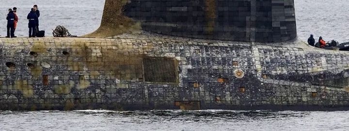 Vanguard goes out a Submarine, comes back a Kraken. - Page 1 - Boats, Planes & Trains - PistonHeads UK - The image shows a scene where an old, dilapidated pier or dock extends out towards the sea. There are two individuals visible in the distance, likely people visiting the site. The water around the dock appears calm, and there is some debris visible on the ground near the edge of the pier. In the foreground, a large piece of masonry is prominently featured, suggesting that the structure may be undergoing renovation or demolition. The overall atmosphere of the image suggests a sense of abandonment and decay, with nature gradually reclaiming the space as it is left to erode.