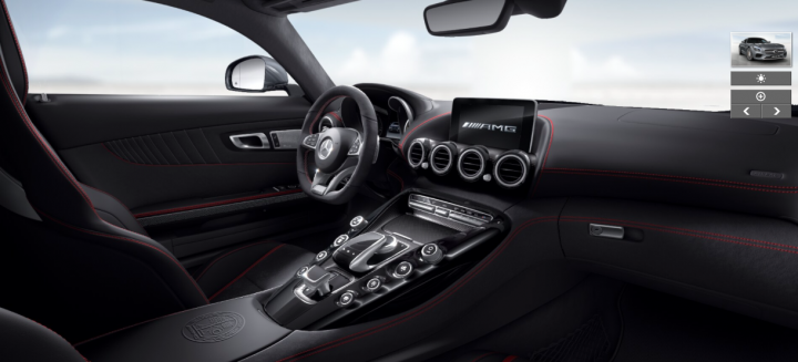 Anyone ordered an AMG GT-S yet? - Page 25 - Mercedes - PistonHeads - The image showcases the interior of an exotic luxury vehicle. The dashboard features a variety of control buttons and a central infotainment screen. The vehicle has a color theme of black, red, and white on the black leather interior. The steering wheel is prominently displayed in the foreground with a logo indicating the make of the vehicle. There's a subtle, motion blur around the vehicle's door, adding a dynamic feel to the image.