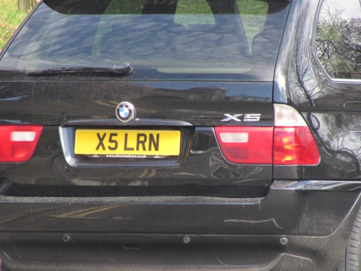 Real Good Number Plates : Vol 4 - Page 315 - General Gassing - PistonHeads - The image features the rear view of a black BMW X5. The car is lined up with a yellow license plate that reads "X5 LRN". The license plate is attached to the trunk of the vehicle. The BMW logo is prominently visible on the trunk door. The design of the car and the license plate number suggest that the image is taken either from another vehicle or from a camera capturing an alignment of the car with the license plate.