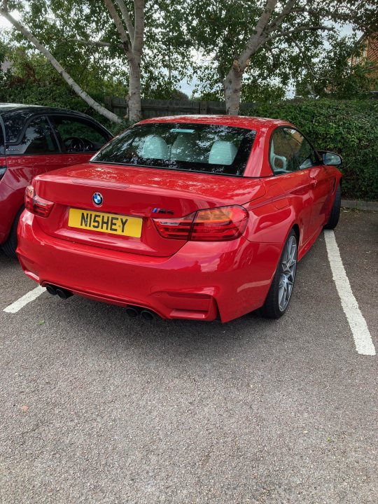 What C124PPY personalised plates have you seen? Vol.3 - Page 516 - General Gassing - PistonHeads UK - The image shows a red BMW parked in a parking lot. The car features the license plate "WMH" and is positioned next to another vehicle, which seems to be a hatchback with a different color scheme. The cars are parked near trees that provide a natural backdrop to the scene. The setting suggests it might be a residential area given the presence of houses in the background. There's no visible text on the image indicating any specific context or message.