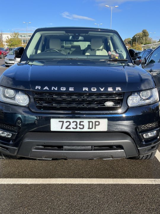 Juvenile things that make you snigger (Vol. 3) - Page 491 - The Lounge - PistonHeads UK - The image shows a black Range Rover parked in a parking lot. The car is positioned at an angle to the viewer, with its front end and side profile visible. It features a standard license plate that reads "7935 DP" and is marked with the model name "RANGE ROVER". There's no text present in the image. The background of the photo includes a clear sky above and a building to the left, suggesting an urban setting.