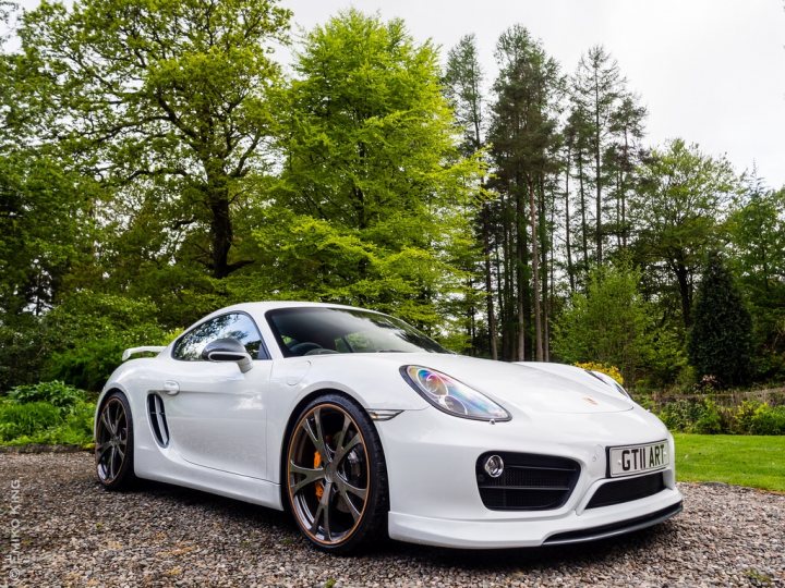 Boxster & Cayman Picture Thread - Page 12 - Boxster/Cayman - PistonHeads - The image showcases a sleek, white sports car parked on a rocky surface. The car is positioned in front of a variety of trees under a partly cloudy sky. The words "GT5" are visible, suggesting a model or ownership claim. The scene conveys a sense of tranquility and posh appeal, typical of a luxurious sports car setting.