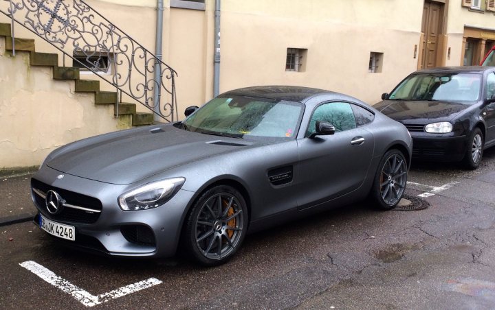 A car parked in a parking lot next to a car - Pistonheads