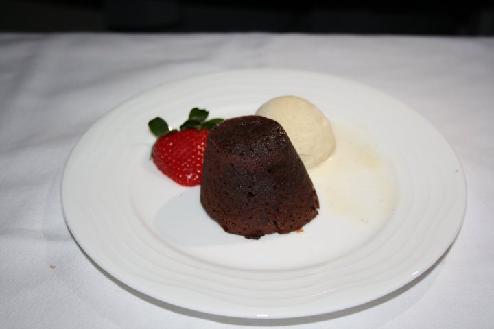A piece of chocolate cake on a white plate - Pistonheads