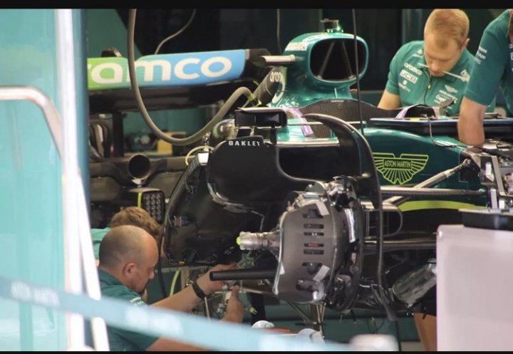 Official 2022 Spanish Grand Prix Thread ***SPOILERS*** - Page 6 - Formula 1 - PistonHeads UK - The image captures a dynamic scene from the pit lane of a Formula One race track. In the foreground, a mechanic in a green uniform is diligently working on the front of a vibrant blue and green Formula One car, which features a striking livery with a prominent logo. 

The car is being serviced at a stand with two mechanics attending to it. The focus of their attention is on the car's engine cover, suggesting they might be performing maintenance or inspection tasks before the start of the race. 

In the background, another mechanic in a matching uniform can be seen working on another car, further emphasizing the bustling activity typical of a Formula One race weekend. The cars and personnel are the main elements in this image, reflecting the intensity and precision required in such a high-stakes sport.