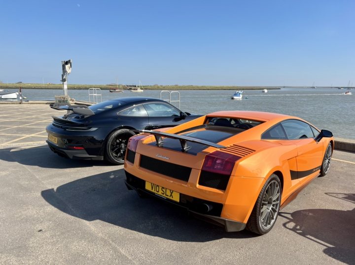 A red car is parked on the beach - Pistonheads