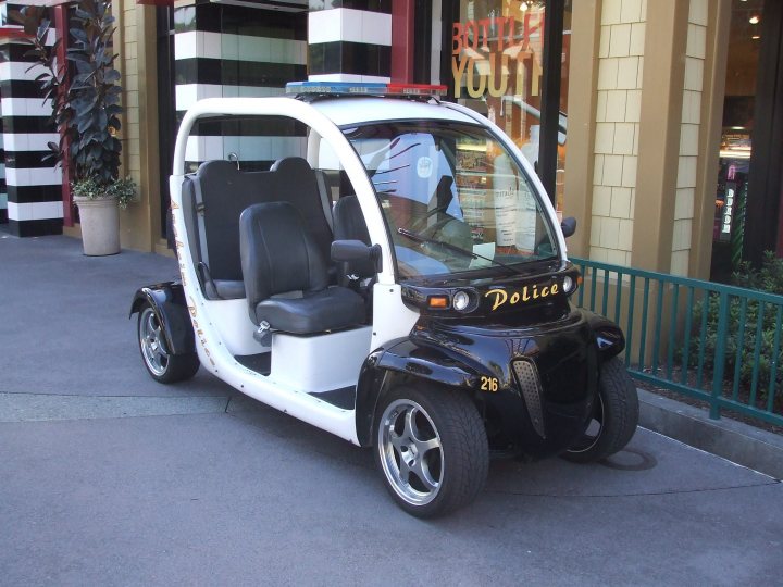 Pistonheads Dust Eat Plod - The image features a fan-??iska g?ices black city mini car patrol vehicle parked on a sidewalk. It has white flared shoulders, a black roof, and a lit yellow sign stating "POLICE" on the front. The vehicle's rear end displays a Badge number "225" next to a gold ribbon. The mini car is unique with two contrasting black seats and silver rimmed wheels. It appears to be a versatile vehicle with all weather gear, suitable for patrol duty.