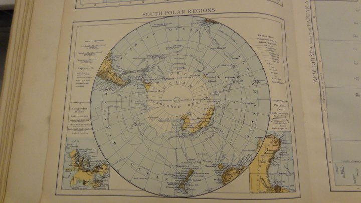 Something different...1895 Times Atlas of the World - Page 1 - Books and Literature - PistonHeads - The image shows an open book displaying a detailed and colorful world map on a two-sided page. The page is centered around a large map with various continents and landmasses, with a circular projection format. On the left side of the page, there is a legend or a key that explains the various symbols and colors used in the map. On the right side, there appears to be a smaller inset map, possibly providing more detailed regional information, though this is partially obscured by the surrounding text. The book has a textured cover and seems to be of a reference nature, given the manner in which the pages are organized and the inclusion of text and additional graphic elements. The overall style is characteristic of traditional reference books, with a focus on providing information in a visual and organized manner.