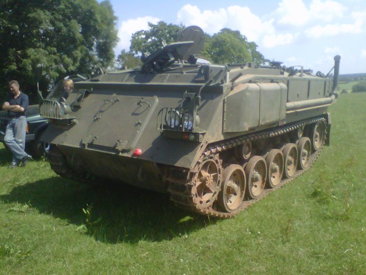 A good day out! - Page 1 - Off Road - PistonHeads - In the image, a large green military truck with six wheels is parked on a grassy field under a partly cloudy sky. The tank-like vehicle, which looks like a small army tank, is positioned with the side facing the viewer, and it's equipped with a turret on top. The area seems to be open, and the vehicle is the central focus of the scene. The grass in the field looks well-maintained, contributing to the overall open space that makes up the foreground of the image.