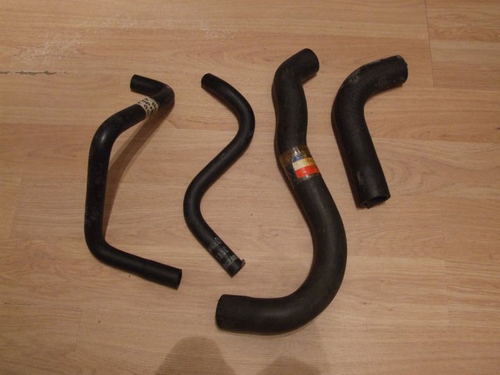 A pair of scissors sitting on top of a table - Pistonheads - This image shows four black exhaust pipes, three of which are broken or damaged. They are all lying on a floor, likely after a harrowing incident. Despite their tattered ends, they continue to radiate an air of ruggedness and resilience. It's a scene of post-event analysis, with one pipe appearing particularly devastated.