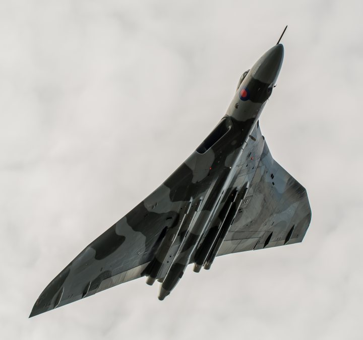 XH558.......... - Page 297 - Boats, Planes & Trains - PistonHeads - The image features a military jet aircraft captured in mid-flight against a backdrop of a cloudy, overcast sky. The jet has a two-tailed design and appears to be equipped with missiles under the wings. Its aircraft body shows a camouflage pattern, common for stealth and tactical purposes. This style of jet is often associated with fighter jets for air superiority and combat missions.