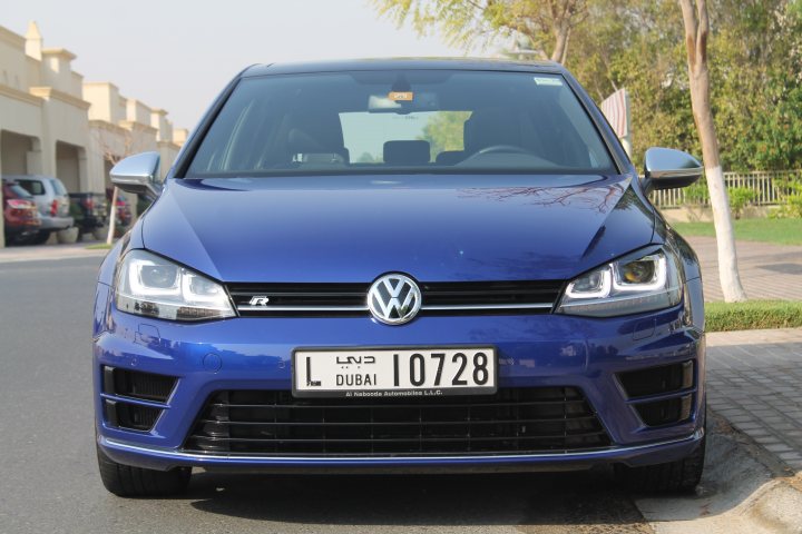 Sold the Golf, replaced with proper car - Page 1 - Middle East - PistonHeads - The image shows the front view of a blue Volkswagen parked on the side of a curb. The license plate is clearly visible and reads "LND 0728." The car appears to be a modern model with a sleek design and shiny exterior. It faces the viewer at a slight angle, giving a clear view of its brand and other distinguishing features. The surroundings suggest a residential area with greenery visible behind the vehicle.