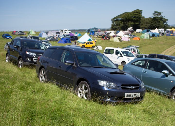 Subaru Legacy 2.0 GT twin scroll - a powerful daily? - Page 1 - Readers' Cars - PistonHeads - The image captures an outdoor gathering of vehicles and tents on a grassy field. A variety of cars, including a hatchback, are parked close together.Camping tents of different sizes and strewn across the field. The scene suggests an event or festival taking place. The weather appears clear and sunny.