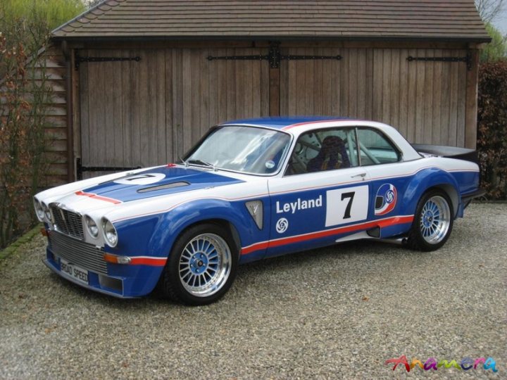 Pistonheads Masculine - The image features a classic blue and white sports car parked in a driveway in front of a wooden shed. The car is an older model, possibly from the 1960s or 1970s, identifiable by its distinctive color scheme and sleek design. The driveway is covered with gravel, and the setting appears to be a residential area. The perspective of the photo is from the front left side, giving a clear view of the car's front end and its side profile. The car features a conventional automotive design with a long hood and short rear tail. The overall condition of the car seems well-maintained, and there is no visible damage or wear.