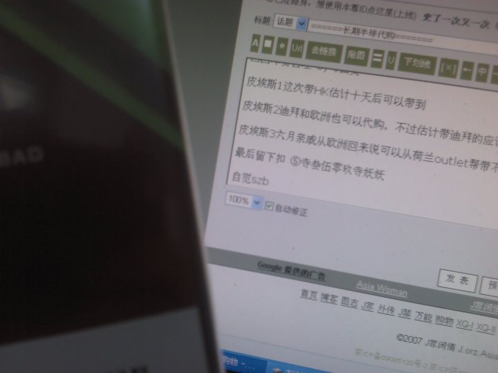 The image captures a moment of working on a computer screen. The screen displays a webpage, most likely a blog or web article, written in Chinese characters. The characters on the screen are a contrast to the black and white image featuring a product displayed in the foreground. The webpage appears to convey some form of information or product review, though the exact content of the Chinese text is not discernible from the image alone. The mixture of scenes creates an interesting visual composition that merges technology with potential commerce.