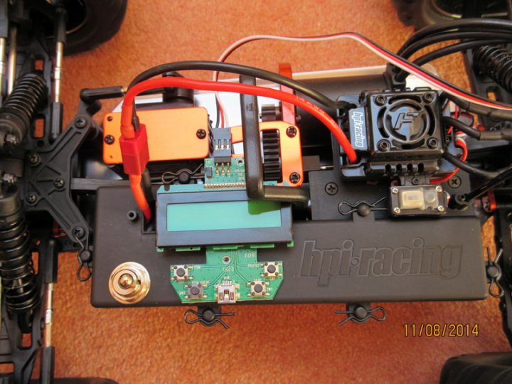 The 1/10 offroad RC thread - Page 1 - Scale Models - PistonHeads - The image shows a close-up view of an electronic device or system. There are several colored wires connecting various components and boards, including a prominent blue board with a screen. There are also black and silver components with labels such as "HPI Racing" and "Piracing," suggesting that this setup is related to radio-controlled vehicle handling or racing. The date "11/09/2014" is written in the bottom right corner. The surface on which the device is placed appears to be a orange carpet.