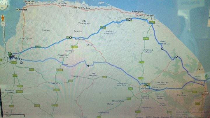 Pistonheads - This appears to be a screenshot from a GPS device or navigation application. It displays a map, primarily covering a portion of the United Kingdom. There are blue lines showing routes and green markers indicating points of interest. The map includes various towns, cities, and roads, with a focus on the area. The surroundings suggest a maritime region with a coastline along one side. The GPS device has symbols and information for the navigation, such as distance to the next turn and the distance to the end of the route.