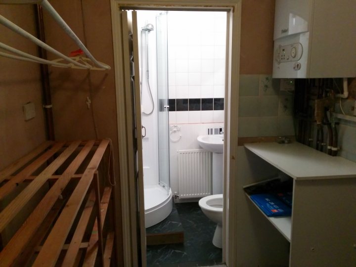 A bathroom with a toilet and a sink - Pistonheads