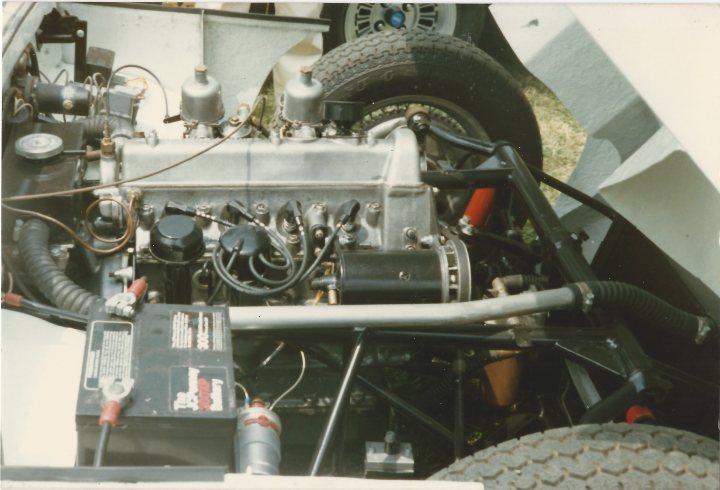 Early TVR Pictures - Page 33 - Classics - PistonHeads - The image shows a close-up view of a car's engine compartment. The engine appears to be a European model, possibly from a vintage vehicle. It's a color photo with a focus on the mechanical components, suggesting a vehicle in need of repair or restoration. The photo captures some details such as hoses, belts, and electrical components close to the engine. The engine compartment is dominated by a variety of wires, hoses, and mechanical parts, indicating a complex setup. The photo may have been taken for documentation or repair purposes.