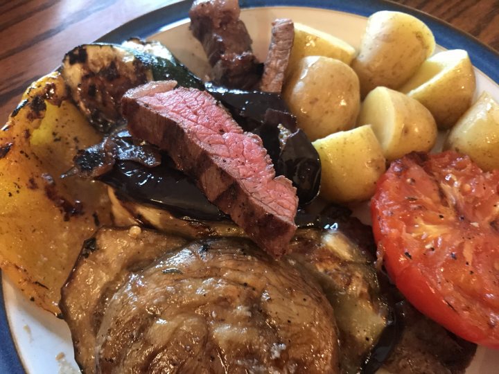 THE  STEAK THREAD, served a la Man. - Page 117 - Food, Drink & Restaurants - PistonHeads UK - The image presents a plate of food with various cooked items. There's a serving of meat, which appears to be steak or roast beef, alongside several roasted vegetables. These include multiple tomatoes and potatoes, some of which are cut in half. The meal is served on a white plate, and it seems to be a wholesome dinner.