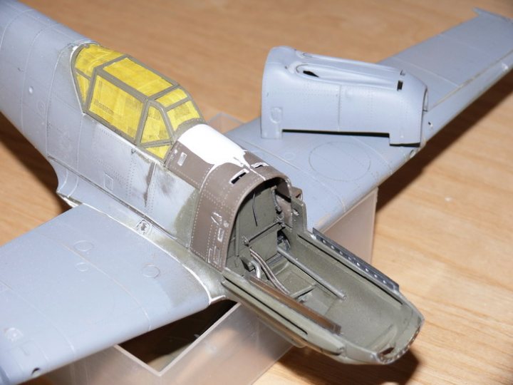 Pistonheads Latest Bfe Matchbox - The image showcases a meticulously crafted model aircraft, predominantly in white. The plane is positioned at an angle, with its wing on the right and nose on the left. The plane exhibits a damaged side, revealing a sight of industrial, gas-like cylinders within. The model aircraft is displayed on a wooden surface.