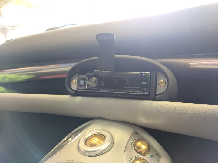 A close up of a cell phone in a car