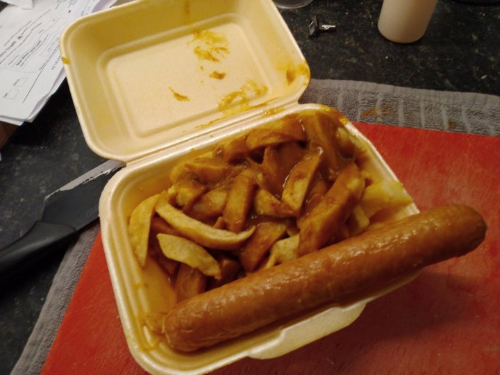 A plate with a hot dog and french fries