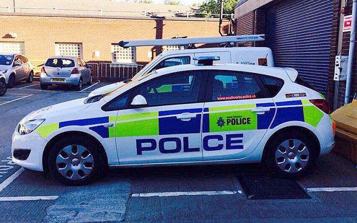 The camera can capture some fantastic moments IV - Page 91 - Photography & Video - PistonHeads - In the heart of a city, a car proudly marked with the words "POLICE" dominates the scene. The car, parked neatly in a space, stands ready on the side of the road. Its distinctive green and blue color scheme immediately catches the eye. The large, white panel on top of it is further adorned with a yellow "X". The background, filled with structures that hint at an urban setting, adds depth to the image. The car appears to be a Mercedes-Benz, known for its reliability and durability.