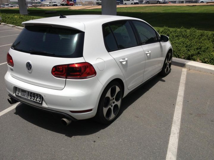 The BAD PARKING Thread [Vol 2] - Page 500 - General Gassing - PistonHeads - The image displays a white Volkswagen Golf parked in a parking lot. The car appears to be a hatchback model, featuring a standard black side mirror and multi-spoke alloy wheels. It has a European license plate, indicating that the photo might have been taken in Europe or by a European driver. The parking lot is spacious with multiple stalls, and the photo is taken during the day under natural sunlight.