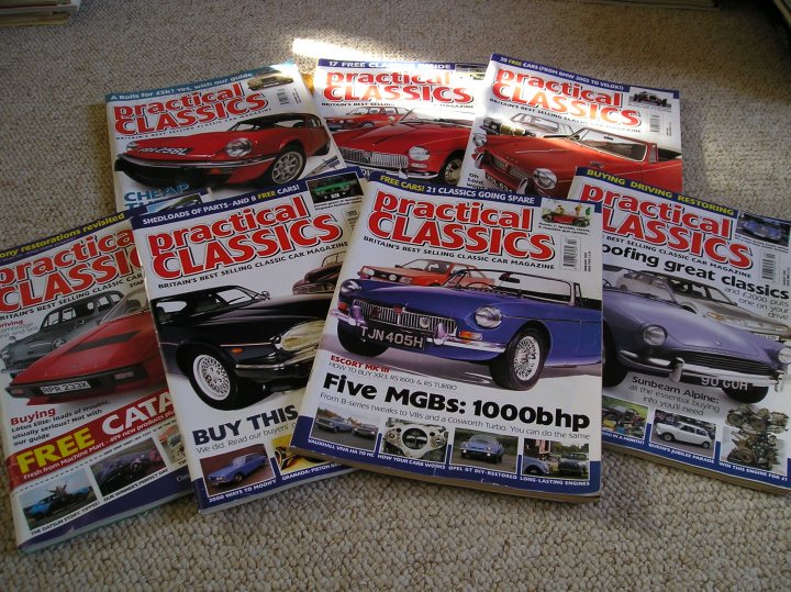 Free Classic Car Magazines [see pics] - Page 1 - MG - PistonHeads - The image shows a collection of car magazines spread out on a carpeted floor. There are five magazines grouped together, each with different cover designs featuring various types of cars. The magazines vary in sizes of their covers, with some having larger images and others with smaller ones. The content of the magazines, as indicated by the titles and descriptions, suggests that they are likely aimed at car enthusiasts or collectors, offering articles, photographs, and information about different makes and models of vehicles. The car on the cover of the front-most magazine is a striking red convertible, adding a pop of color to the arrangement.