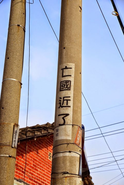 A pole with a street sign on it