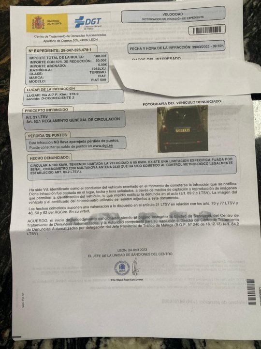 Speeding ticket in Spain  - Page 1 - Speed, Plod & the Law - PistonHeads UK - The image shows a paper document resting on a surface, with a focus on the details printed in Spanish. The document contains various pieces of information, including what appears to be an invoice or billing details. It has the typical structure of such documents, with lines for the sender's and recipient's information, and spaces for the date, type of transaction, and specific items or services listed.

In the top left corner, there is a logo that resembles a flag, possibly indicating nationality or location, but it's not clear enough to identify it. The document has been slightly crumpled and is partially obscured by another piece of paper on top of it. This suggests that the document may have been handled roughly or was left casually among other papers.

The background of the image is quite nondescript, with a focus on the document itself. There's no clear indication of the setting in which the photo was taken, so the environment isn't a significant part of this description. The overall impression is of an ordinary document that has been casually placed and captured in the photograph.