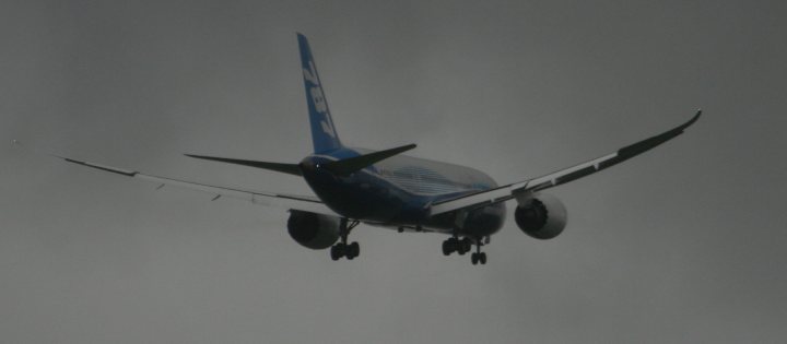 A large passenger jet flying through a blue sky - Pistonheads