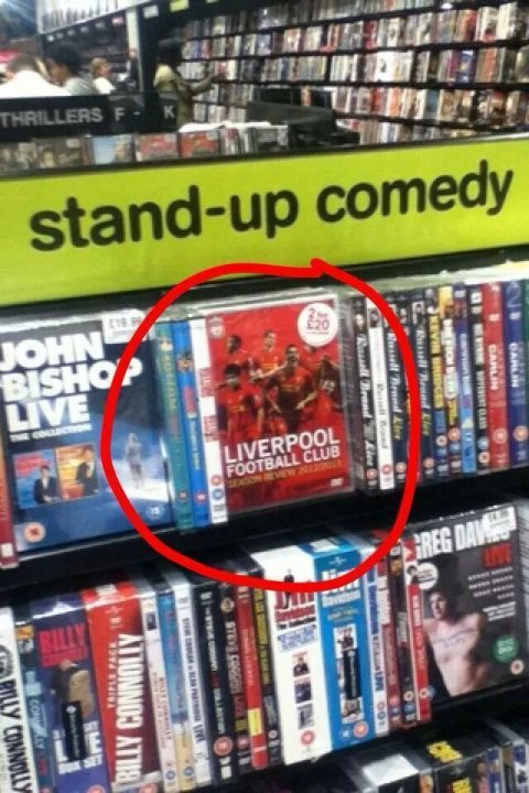 A book shelf filled with lots of books - Pistonheads - The image captures a section in a shop that is dedicated to humor. This section is prominently displayed and is bordered by a yellow sign. The main focus of this section is a collection of movies. The movie selected for the cover image of the section is "Livepool Football Club" which is mentioned on it. This cover image is surrounded by an array of DVDs and a book, which are arranged on a shelf. The arrangement suggests that these items are readily available for purchase.