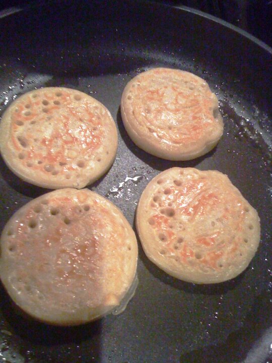 Hairy Bikers Pistonheads Mums - This image captures a moment in a kitchen where four golden brown pancakes are resting in a non-stick frying pan. They are cooked to perfection, their edges slightly crisped, and their surfaces evenly browned. Each pancake has a unique texture, with the flour giving them a rough, porous appearance that contrasts with the smooth surface of the pan. The dish gives off an inviting odor, suggesting that a delicious breakfast is being served or prepared. The setting appears to be a kitchen, with the pan and its contents being the primary focus of the image.