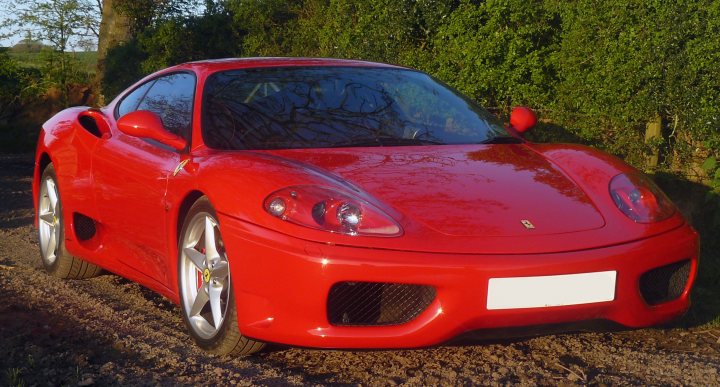 A red sports car is parked on the grass - Pistonheads