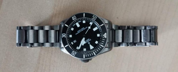 Problem with Tudor Pelagos - Page 1 - Watches - PistonHeads - The image shows a wristwatch with a stainless steel band and case. It has a black dial with white markings, indicating the hours on a 12-hour scale. There are three smaller dials within the main one, which might represent chronograph functions or additional information such as day of the week and date. The watch has a luminescent hands and hour markers for easy visibility in low light conditions. It appears to be a mechanical watch with automatic winding capability, as indicated by the presence of an exhibition case back where the movement can be viewed.