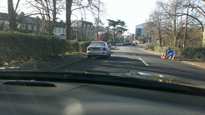 A car driving down a street next to a traffic light - Pistonheads