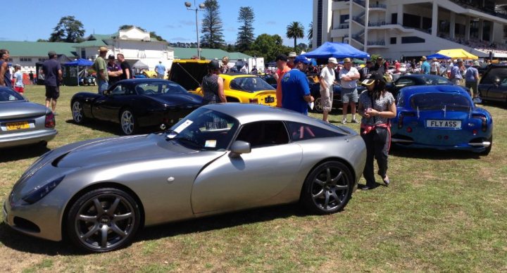 Spotted.... - Page 24 - New Zealand - PistonHeads - The image captures the essence of a vibrant car show. It's set on a lush green field under a clear blue sky. The field is populated with a dazzling array of cars; a mix of sleek, old, and brightly colored, all parked side by side. Some cars boast shiny chrome, while others have a vintage appeal, adding a touch of history to the scene.

Dotted around the field are people, their faces filled with admiration as they inspect the vehicles up close, creating an atmosphere of shared appreciation for the automotive world. The festive atmosphere is accentuated by a few umbrellas providing shade against the sun, and a white building standing as a symbol of the event's location. The image, in its entirety, paints a picture of a day dedicated to the celebration of cars and automotive culture.