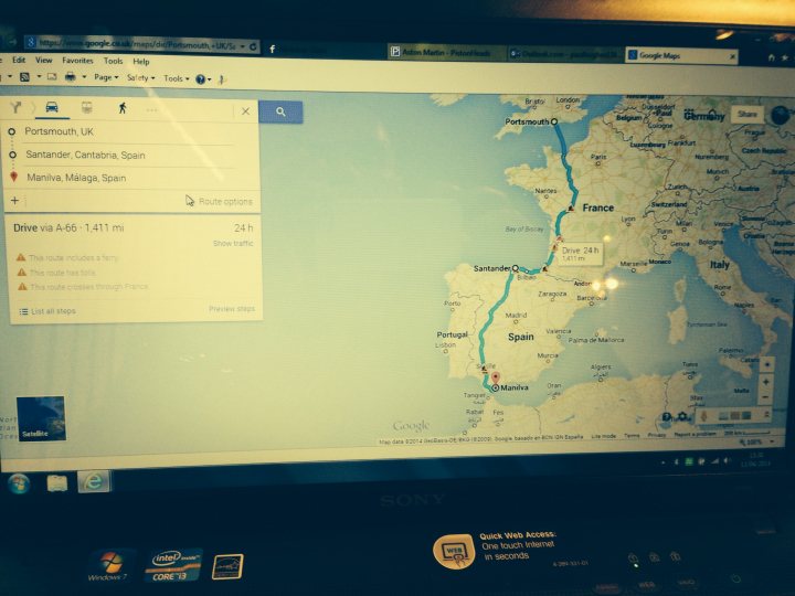 Spain Trip - Page 1 - Aston Martin - PistonHeads - The image displays a laptop screen showing a map with a route planned to drive from Montpellier to Catalonia in two days. The route is marked from the departure point in Montpellier to the destination point in Catalonia. The map is viewed in Google Maps and indicates the route is 146 kilometers long. There appears to be a warning message at the bottom of the screen, but the text is not entirely legible. The laptop is placed on a table, with a keyboard partially visible in the foreground and the room's ambient light glowing on the screen.