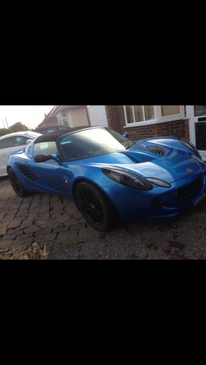 A car is parked in front of a parking meter - Pistonheads - The image shows a blue sports car parked on a street. The car's sleek design and aesthetically pleasing color make it stand out. The vehicle has a distinctive black wheels, and the overall image seems to be taken during the day as indicated by the natural lighting. The car is positioned towards the center of the frame, and there's a glimpse of a building in the background.