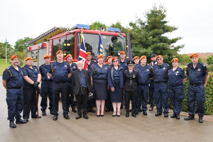 Misfits, Dad's Army Types et al... - Page 478 - The Lounge - PistonHeads UK - The image captures a group of firefighters, police officers, and other first responders posing together. They are gathered around an open fire truck, which is prominently displayed in the background. The individuals are dressed in their respective uniforms, signifying their roles as emergency personnel. Some members of the group are wearing ties, suggesting a formal or official event. A few people are standing slightly apart from the rest of the group, adding depth to the composition of the photograph. The presence of a flag and a badge further emphasizes the ceremonial nature of this gathering.