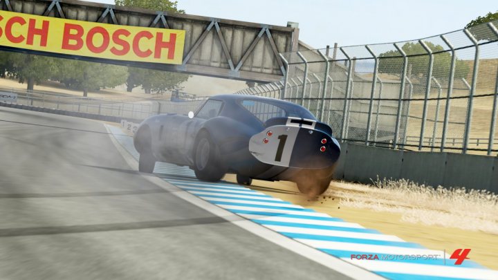 A person is riding a skateboard on a ramp - Pistonheads - The image captures a dramatic moment on a racetrack at Bosch. A Formula 4 racecar, bearing the number 1 and the text "BOSCH" on its hood, is in full action on the corners. The car leans significantly to the left, indicative of a high-speed corner, with its rear side slightly lifted, suggesting speed and the adrenaline rush of motorsport. The racetrack is enclosed by a metal fence, and the striped curb stands out against the smoother tarmac, emphasizing the high-speed maneuvering.