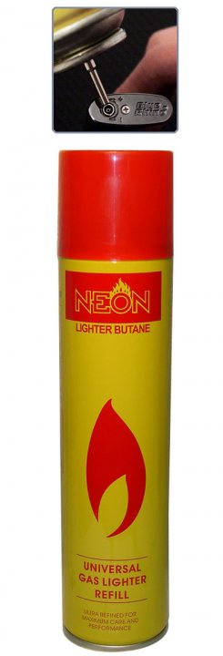 Pistonheads Fill - This is an image of a gas lighter container. The container is predominantly yellow with red and black text and artwork. The logo "NEON" is visible, and the text includes "IGNITOR PUMPER" at the top and "UNIVERSAL GAS LIGHTER REFILL" towards the bottom, with additional wording indicating "HPG Gas Pump Complex". A finger and thumb are in the process of holding a small component, possibly the cap, for the lighter. A red safety flame tip icon is also depicted at the bottom.