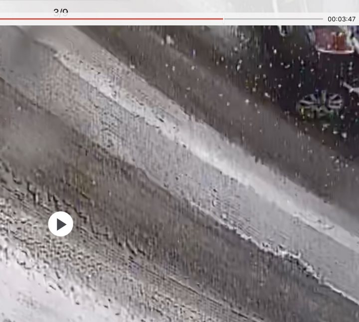 Help Identifying Car - Page 1 - General Gassing - PistonHeads - The image depicts a wet urban scene, possibly taken from a moving vehicle or security camera. A dashed white line runs along the lower edge of the frame, suggesting it might be a road or sidewalk. The surface appears to be a wet pavement, and the surroundings seem to be wet as well, indicating recent rain. There are blurred objects in the background, which may include vehicles or pedestrians, but the specifics are difficult to discern due to the motion blur effect. The image seems to capture a quick snapshot of the environment.