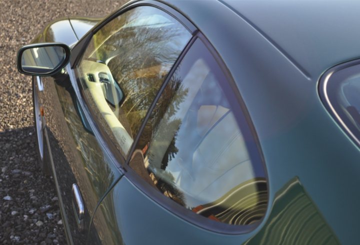 A car is reflected in a rear view mirror - Pistonheads