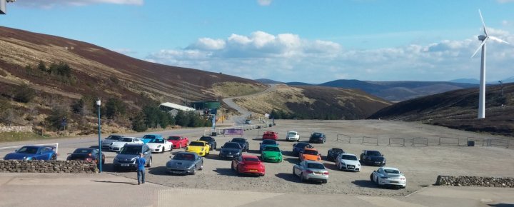 A group of people standing on top of a sandy beach - Pistonheads