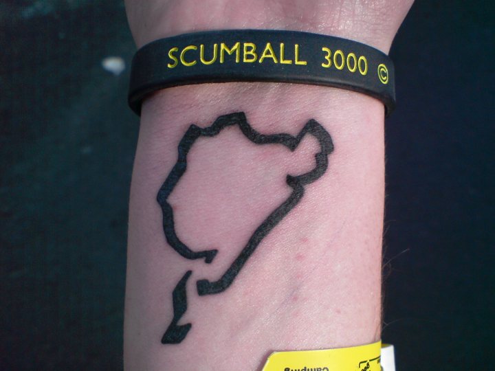 Awful Nurburgring Stickers Pistonheads - The image shows the lower half of an arm, tattooed with a province map of France. Above the tattoo, the person is wearing a bracelet with the text "SCUMBALL" visible on it.