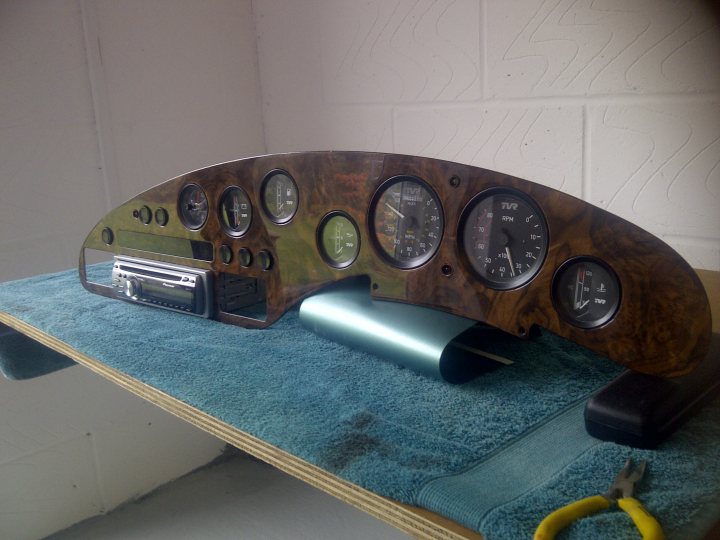 A clock on a wall next to a mirror - Pistonheads